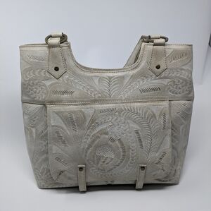 Leaders in leather hand-tooled shoulder bag
